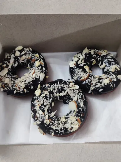 For a bit of crunch, I offer these chocolate donuts topped with a generous amount of sliced almonds. The nutty flavor is a great combination with the rich chocolate glaze.