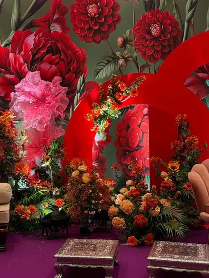 An identical image to 67, showing the vibrant and creative decor for a pre-wedding celebration. The mix of bold colors, patterns, and textures creates a festive and artistic environment.