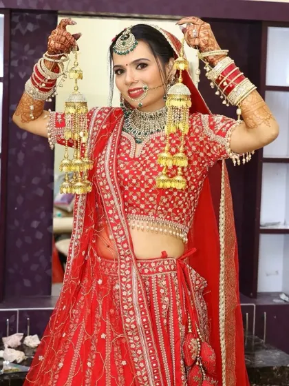 A playful pose with the kalire. This shows the full effect of the bridal makeup and hair in a candid moment.