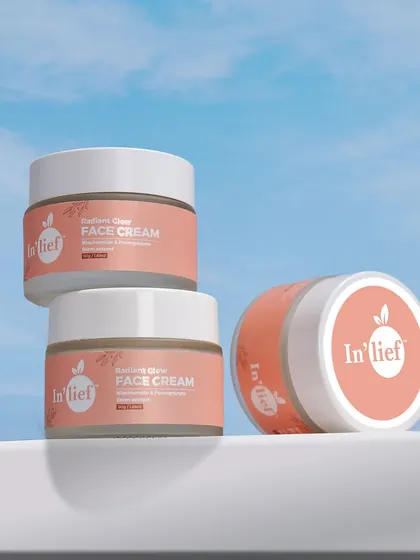 A creative composition of In'lief face cream jars stacked against a sky background. This conceptual shot is great for social media campaigns and branding.