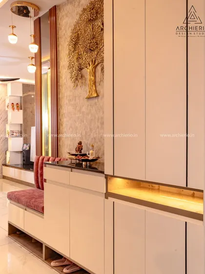 This foyer unit combines a seating bench with shoe storage and a tall cabinet, all elegantly designed with a gold tree-of-life mural as a backdrop.