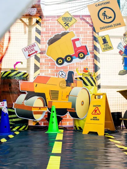 A close-up of the construction zone decor, featuring a road roller cutout, a 'Digging Zone' sign, and a road-themed floor.
