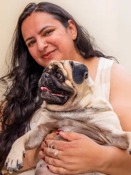 A pet parent sharing a warm embrace with her pug. These are the cozy, heartwarming moments I love to capture.
