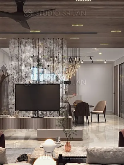 A view from the seating area towards the dining space in the Janakpuri home, showing how a textured partition behind the TV provides a subtle sense of separation.