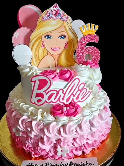 This two-tiered Barbie cake is a princess's dream, with pink ombre ruffles and a sparkling tiara for a glamorous 6th birthday.