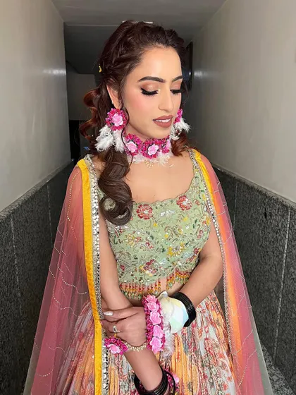 Another shot of this dreamy and minimal Mehendi look. The focus is on flawless skin and a soft eye, letting the colorful floral jewelry make a statement.