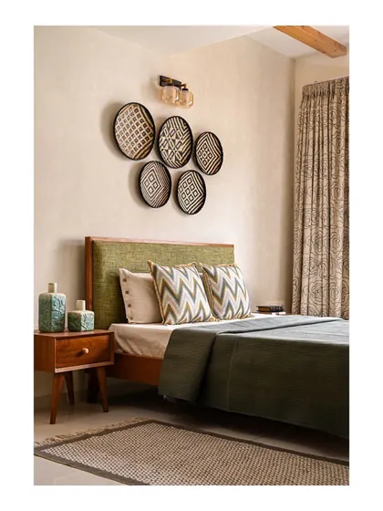 A full view of the earthy guest bedroom, where a textured wall is juxtaposed with hand-woven baskets and a khadi green headboard.