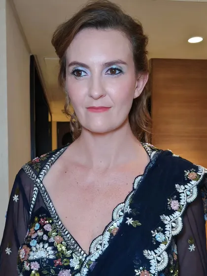 A close-up of her icy blue eyeshadow. It's a bold choice that pays off, creating a stunning and memorable party makeup look.
