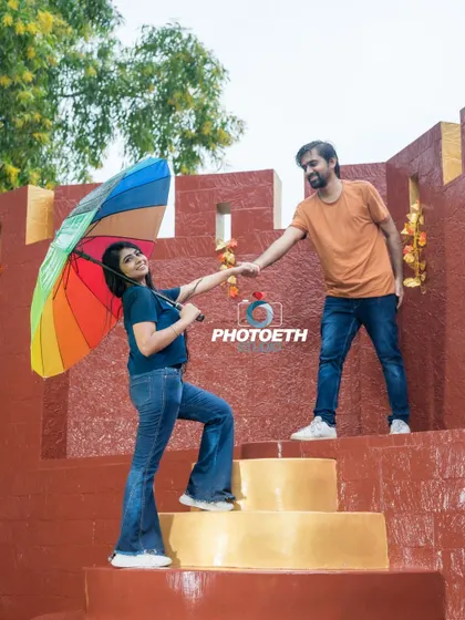 A playful moment with a rainbow umbrella on a set designed to look like ancient steps. This shows how we can have fun even with simple props.