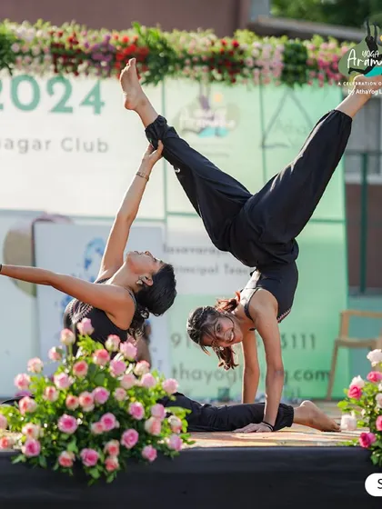A beautiful display of strength, trust, and balance with this partner yoga pose on stage at Yoga Arambha 2024. Our events often feature performances that showcase the artistic side of yoga.