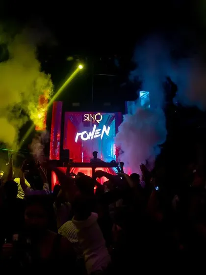 A mix of yellow and blue smoke fills the air at SinQ, Goa.