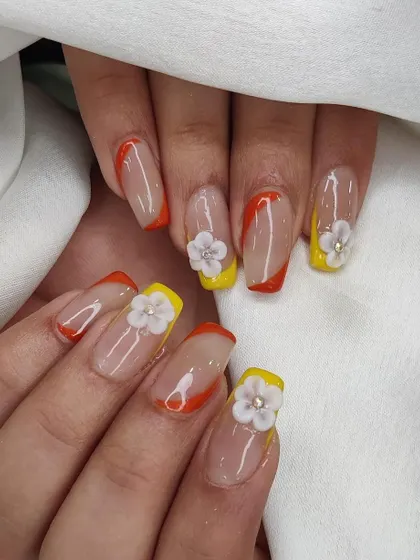 A full view of the colorful French manicure with hand-sculpted 3D flowers, a perfect design for spring or summer.