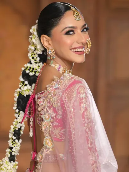 This over-the-shoulder shot captures the bride's joyful expression and the beautiful floral braid. It shows how a traditional hairstyle can feel fresh and modern in a campaign setting.