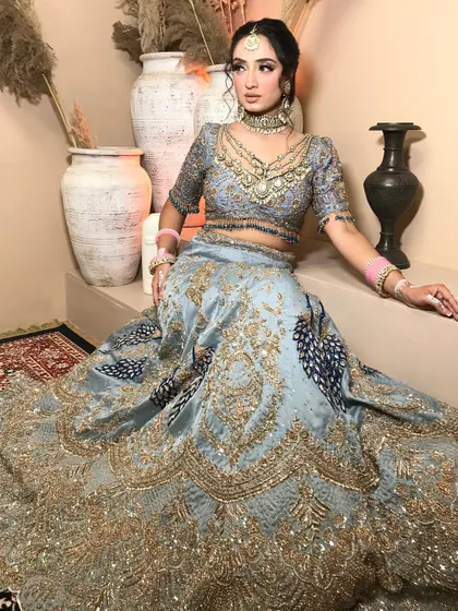 Another full-length shot of the powder blue lehenga, showing how the bride carries the grand outfit with grace and elegance.