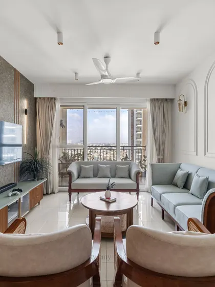For this compact living room at Shapoorji Pallonji Parkwest, we focused on making the space feel light and open. We used customized wooden sofas with contrasting fabrics and simple arch details to create a balanced, functional, and aesthetically rich area.