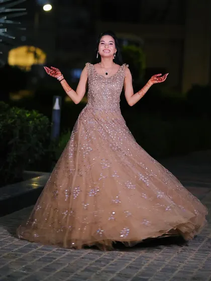 A happy and twirling bride-to-be at her engagement shoot. The full gown and elegant makeup create a fairytale moment.