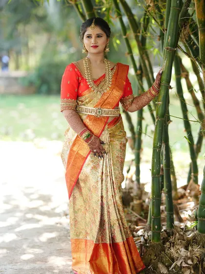 A duplicate of the previous image, showing the client's beautiful orange and cream saree.