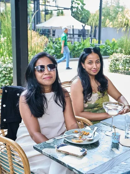 Two friends enjoying a quiet meal and conversation in our beautiful outdoor seating area.