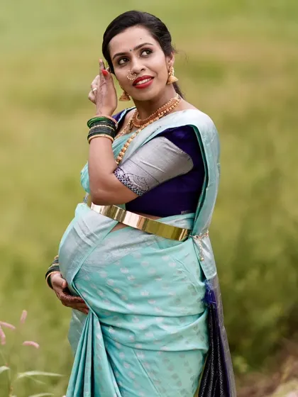 A side profile showing the hairstyle and glowing makeup for this baby shower. The focus is on creating a look that feels comfortable and beautiful.