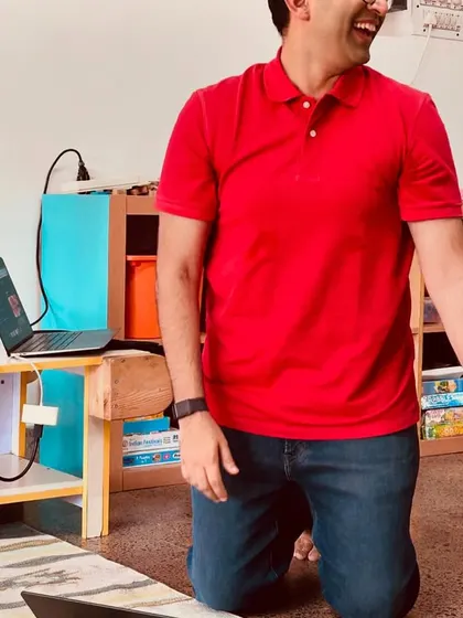 A parent who is an expert in AI demonstrates how new technology can be a tool for creativity, sparking laughter and curiosity among our Playmakers during a training session.