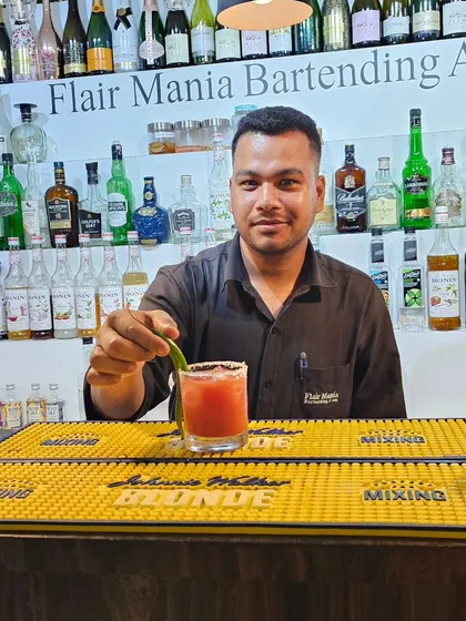 A student at our Goa branch proudly presents a freshly made mocktail, showing that our non-alcoholic options are crafted with the same care and skill.