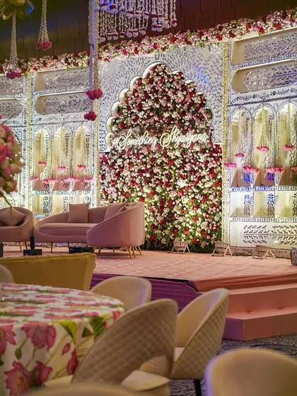Another angle of the beautiful pink and white stage. The plush pink sofas and the custom neon hashtag create a perfect focal point for the couple.