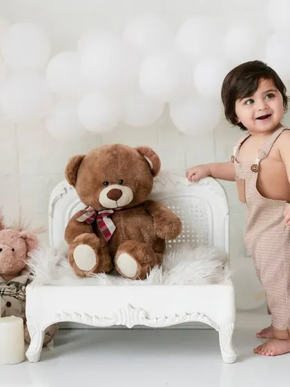 A simple and sweet moment from a first birthday shoot. The neutral tones and teddy bear friends create a warm and timeless portrait.