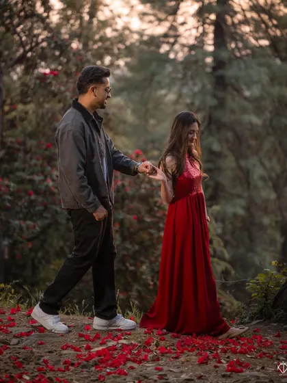A romantic walk through a path of scattered petals in the forest, leading his partner by the hand. This is a perfect example of creating a fairytale moment.