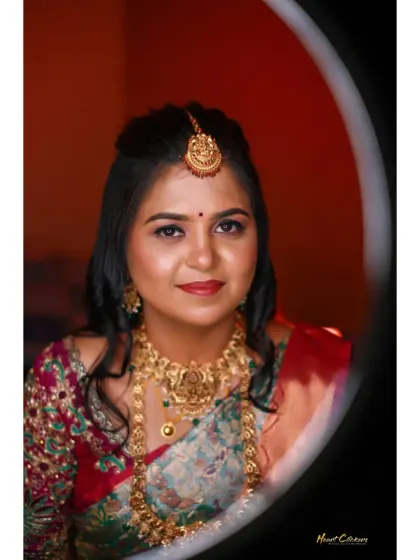 A classic bridal portrait, beautifully lit to showcase her traditional jewelry and serene expression.