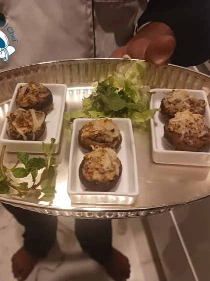 A platter of baked stuffed mushrooms, a classic vegetarian starter.