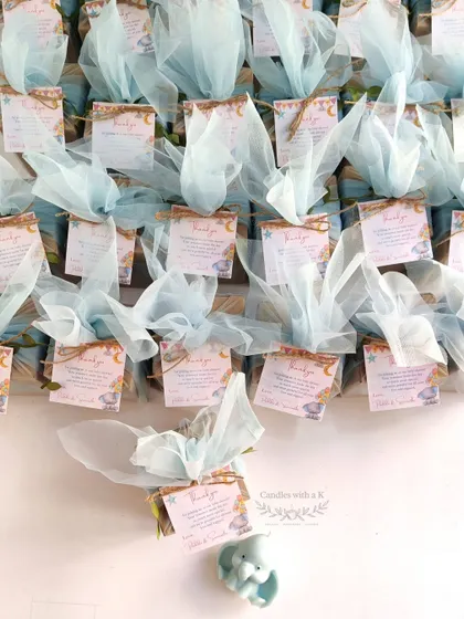 The final packaged baby elephant candles, each in its own box with a personalized thank you card, ready to be gifted at Padma's baby shower.