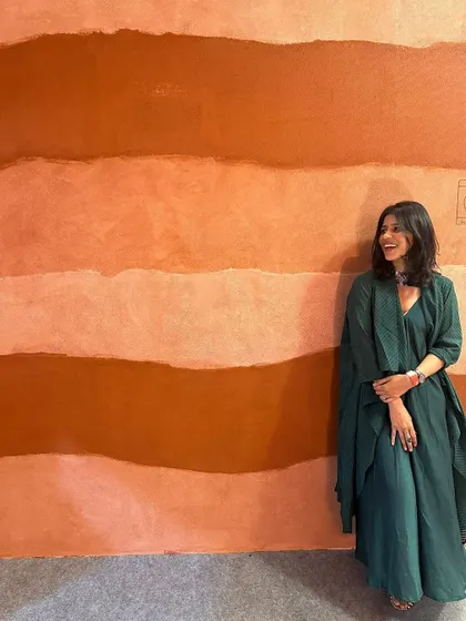Another shot of my green cotton dress against the beautiful textured wall at the art exhibit. The color and silhouette really pop.