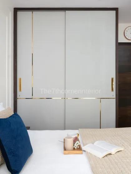 This image showcases the custom sliding wardrobe with frosted glass and gold inlay, which complements the tranquil and sophisticated aesthetic of the master bedroom.