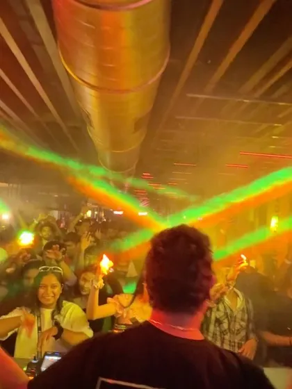 A view from behind the decks in Belgaum, with the crowd lost in the music and the lights.