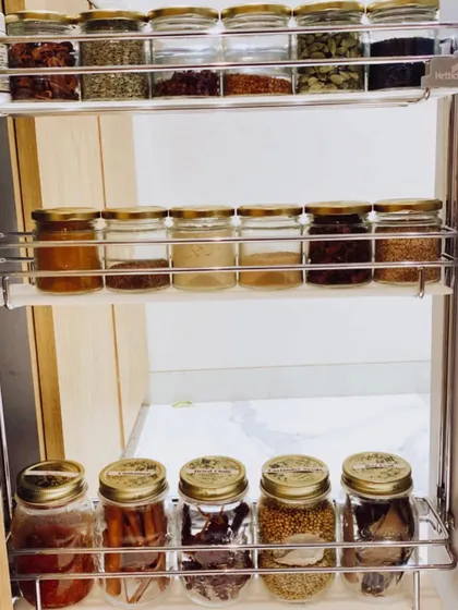 A beautiful and functional spice rack. Using uniform jars and arranging them on a tiered rack makes every spice visible and easy to grab while cooking.