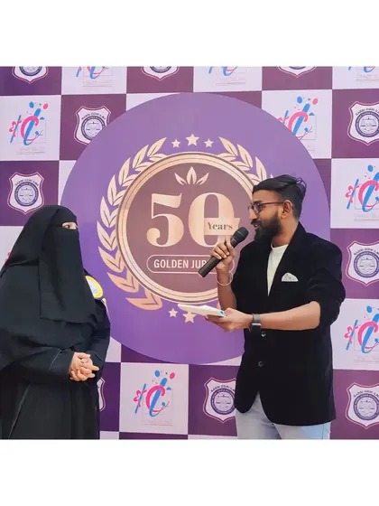 Keeping the crowd engaged is key to any successful event. Our professional emcee is seen here interacting with a guest at a golden jubilee celebration, ensuring the energy stays high and the event runs smoothly.