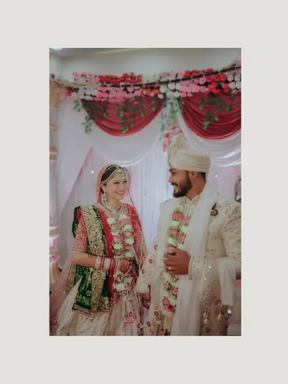 A classic portrait of the bride and groom after the ceremony. Their happy smiles and intertwined hands tell the story of their new beginning.