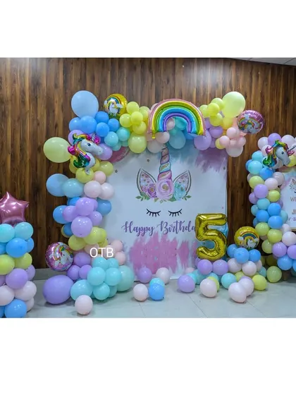 A magical unicorn theme for Jinisha's 5th birthday. This setup uses a pastel rainbow of balloons, unicorn and rainbow foil balloons, and a custom backdrop to create an enchanting party atmosphere.
