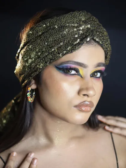 A close-up of the vibrant eye makeup, showing the sharp lines and intense pigmentation.