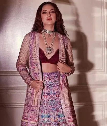 Sonakshi Sinha's multi-colored embroidered lehenga with a jacket is a work of art. I can create a similar piece for you, focusing on intricate, colorful threadwork.