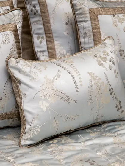 A close-up of a pillow from our Essential Grey Jacquard Bed Cover set. The rich jacquard weave and nature-inspired botanical design add a touch of refinement to your bedroom.