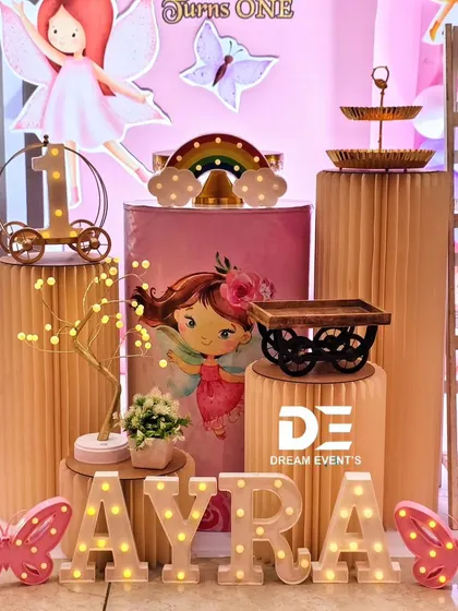 Detailed props from Ayra's fairy-themed birthday, including marquee letters of her name, light-up butterflies, and themed pedestals.