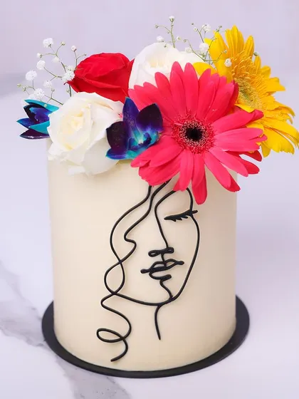 We celebrate the beauty of femininity with this modern line art cake. A minimalist silhouette of a woman's face is drawn on a pristine white canvas, crowned with a vibrant bouquet of fresh, colorful flowers, creating a cake that is both art and dessert.