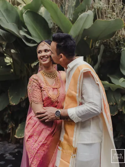 A duplicate of 214, a sweet and candid moment of the groom kissing his bride's cheek.