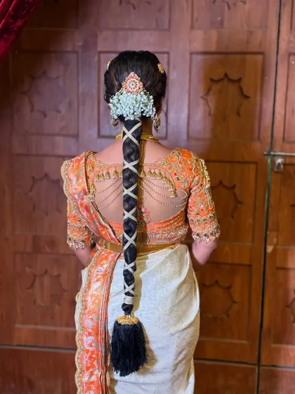Another angle of the beautiful criss-cross braid, showing how the style perfectly complements the bride's entire ensemble, from her hair to her detailed blouse.