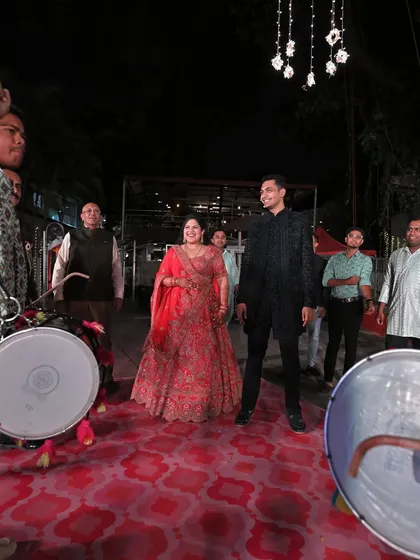 The couple making their grand entrance to the Sangeet, welcomed by the energetic beats of dhol players. We coordinate with all vendors to ensure every moment is perfectly timed.
