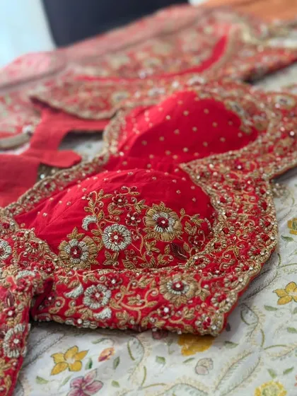 The front of the red blouse, showing the padded cups and intricate embroidery.