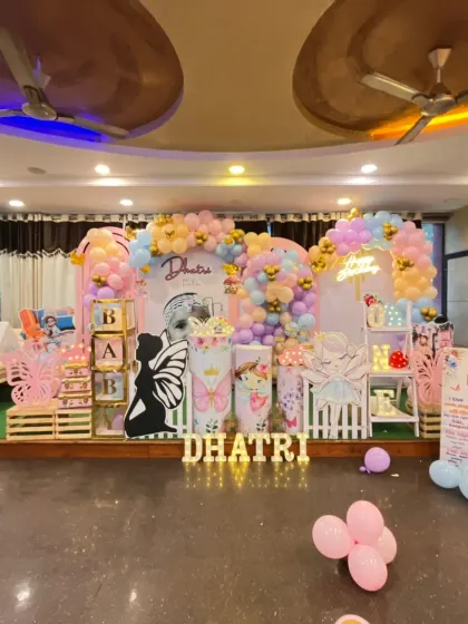Let us create a whimsical birthday celebration for your little one. This expansive butterfly-themed decor features multiple props, custom name lighting, and pastel balloon arrangements to create an enchanting party space.