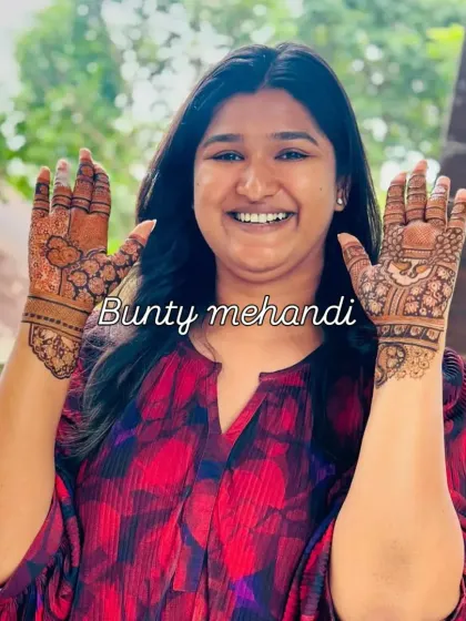 A happy client showing off her simple yet beautiful palm designs. We ensure every guest leaves with a smile and a lovely mehandi pattern.
