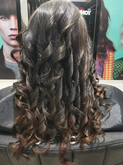 Curls are a fantastic way to show off the intricate work of highlights. Each curl catches the light differently, revealing the beautiful honey and caramel tones.